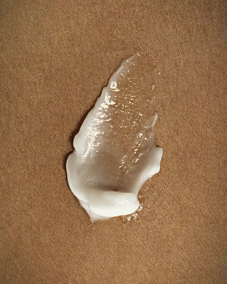 Facial at home in Dubai, rich cream texture on warm skin