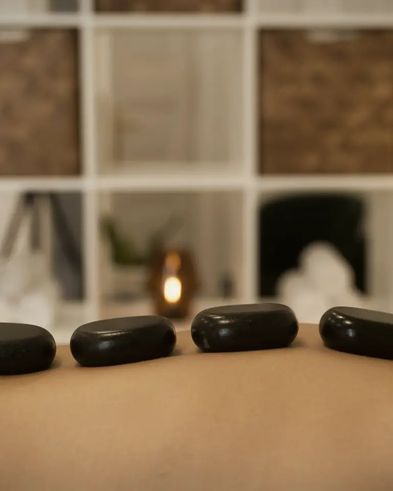 Hot stone massage in Dubai, warmed basalt stones placed along a client's back
