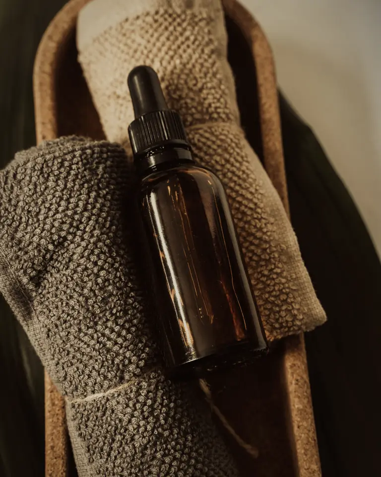 Massage oils and rolled towels ready for a massage at home in Dubai