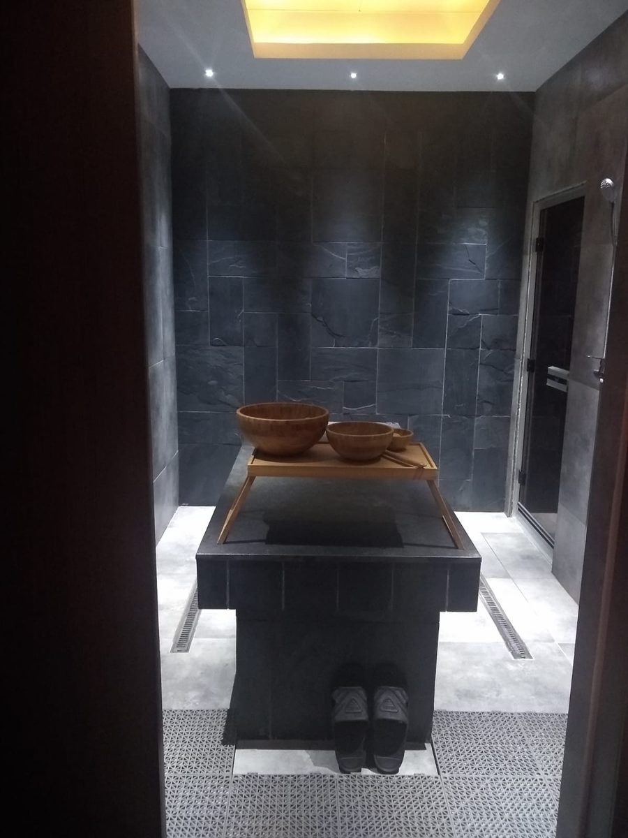 The Moroccan bath and steam room at the Al Garhoud spa centre, in dark slate stone